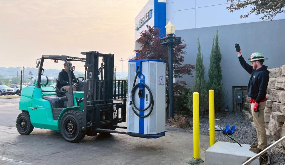 electrician on forklift setting exterior commercial Level 3 DC Fast Charging EV charger outside of Chevrolet dealership