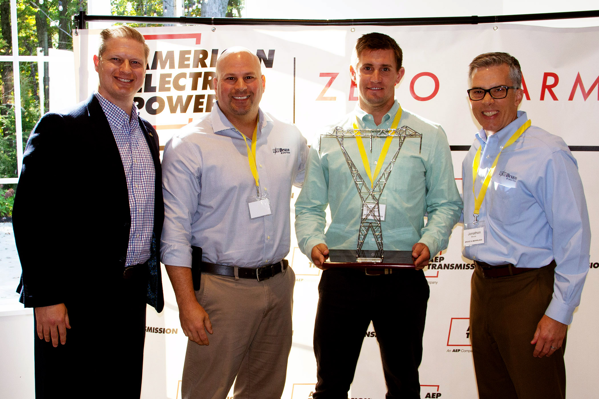 AEP and B&M representatives pose with award