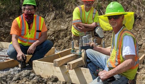 Highway Construction Workers Pose With Award