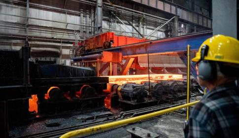 A steel slab moves through the new walking beam furnace at NLMK in Farrell