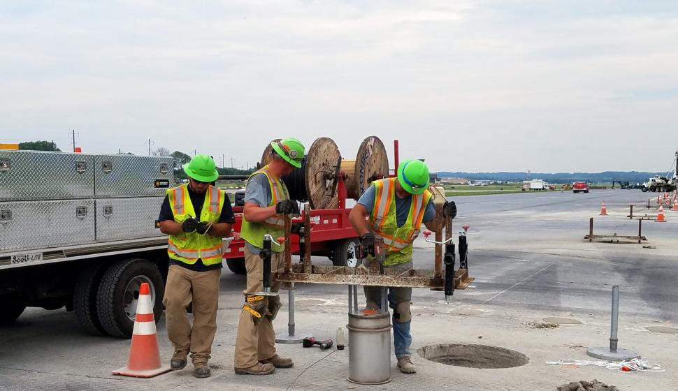 Electricians pre-assemble runway lights