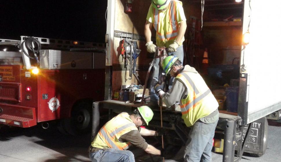 Crews work at night, running cable for new in-pavement lights