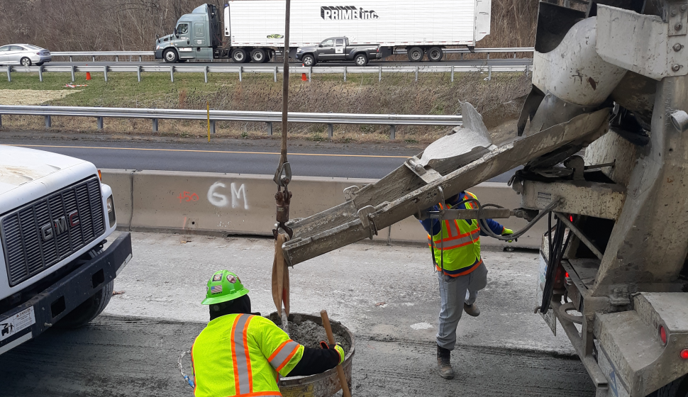 Crews prepare the concrete that will be poured for new highway lighting foundations