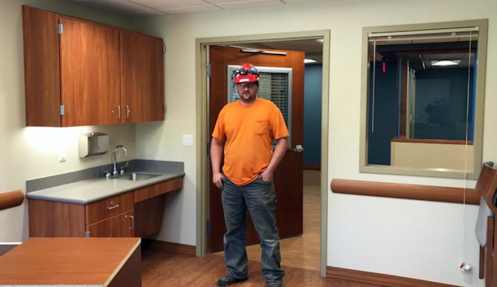 Foreman Ron Lipscomb stands in a completed exam room