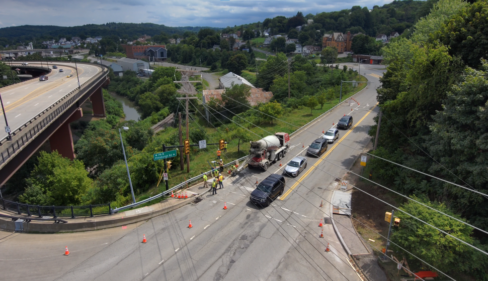Aerial view of concrete and construction trucks at intersection