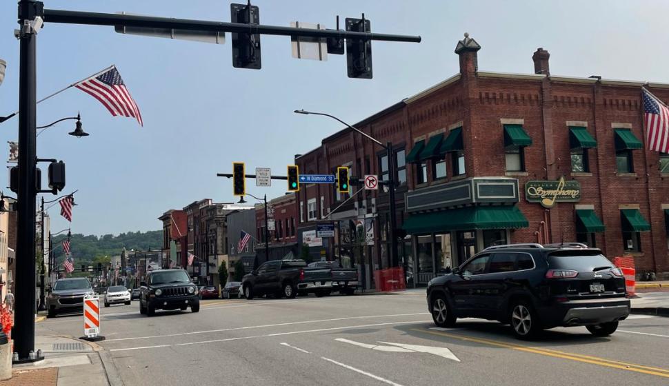 Traffic passes under new decorative traffic poles at Butler intersection