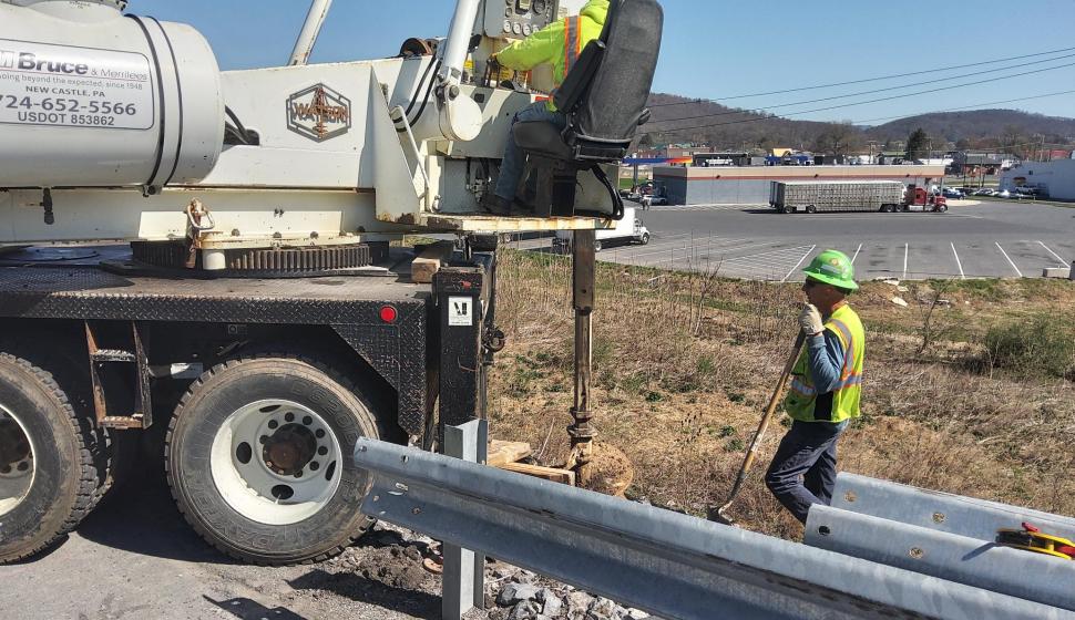 Heavy highway drill operator with groundhand
